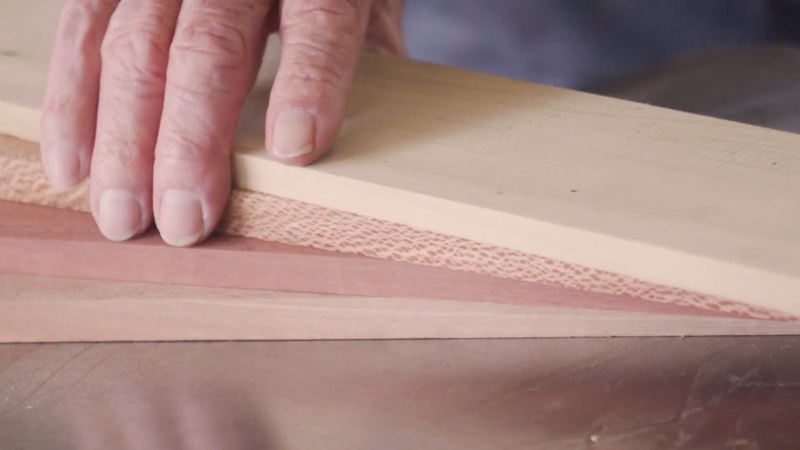 Close-up of a hand on a length of timber